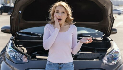 Потрясенная женщина рядом с разбитой машиной